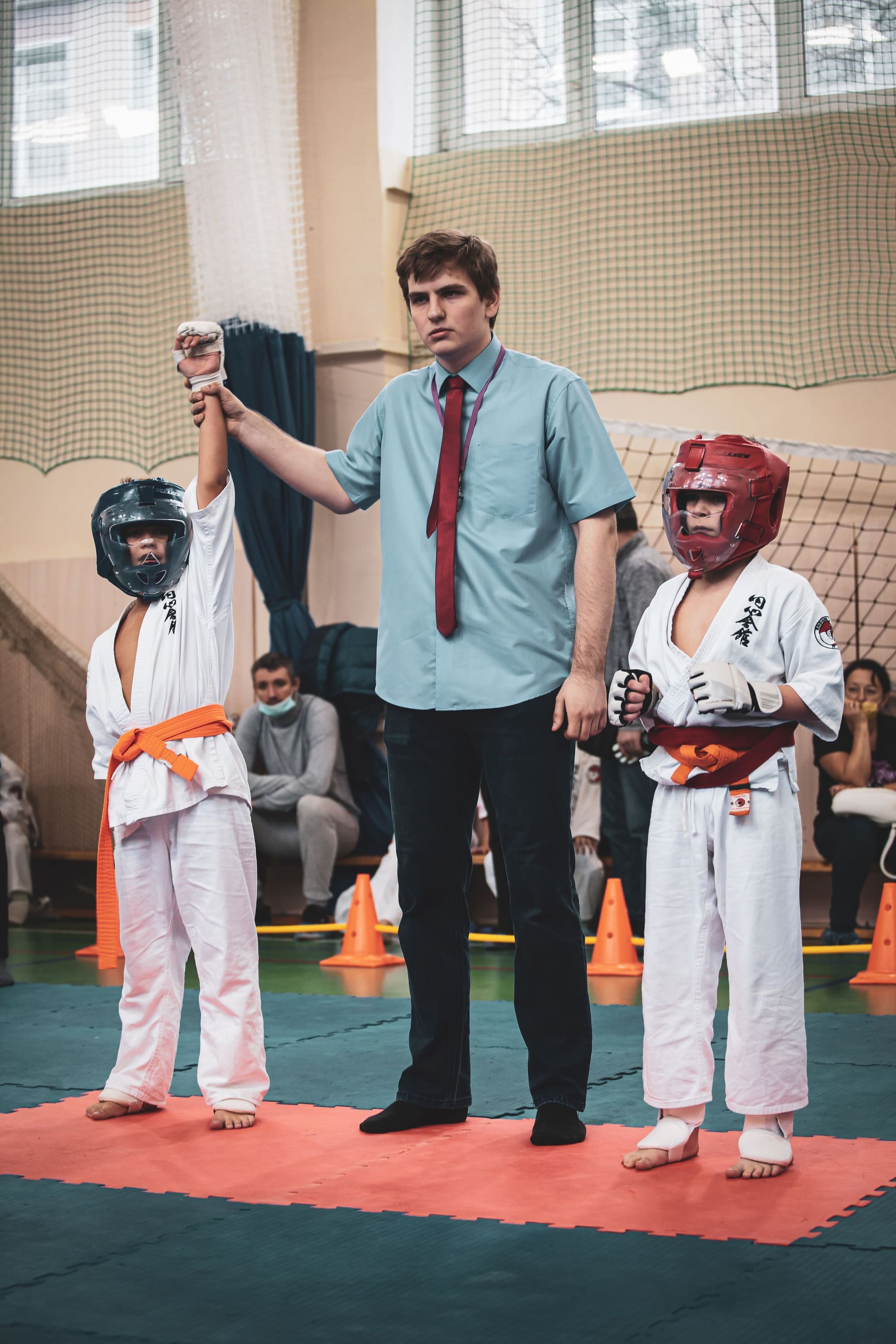 Referee declaring a winner between two competitors