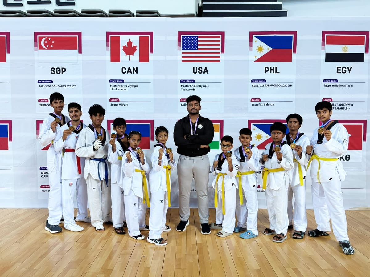 Taekwondo athlete celebrating victory under arena lighting