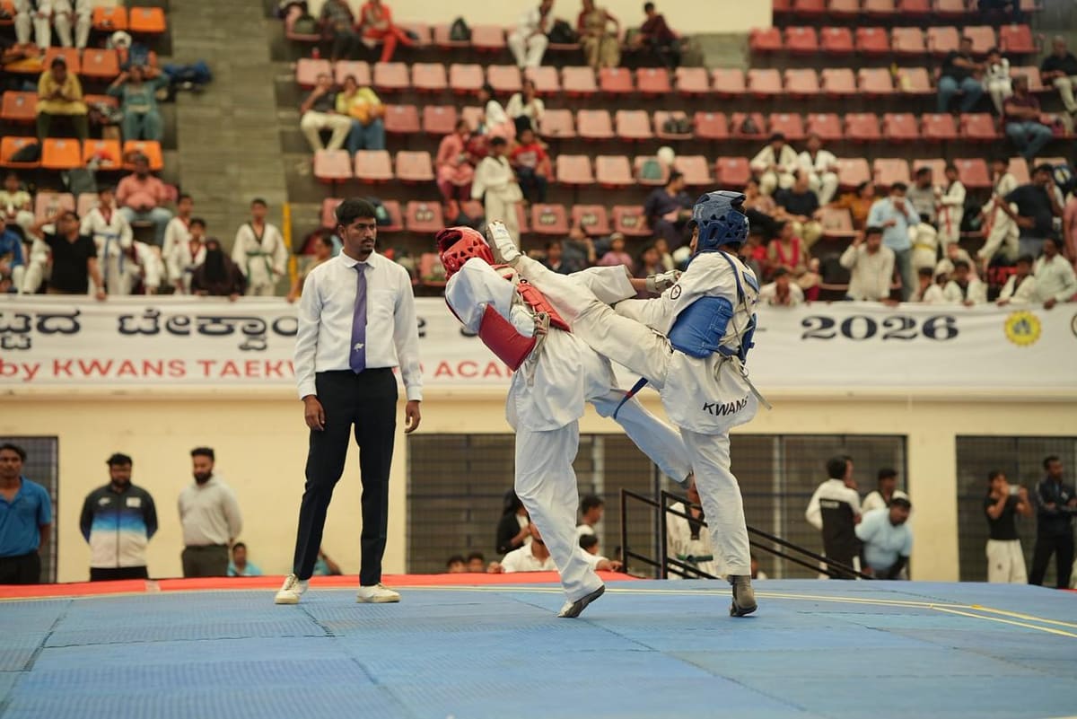 Two athletes sparring during a taekwondo tournament